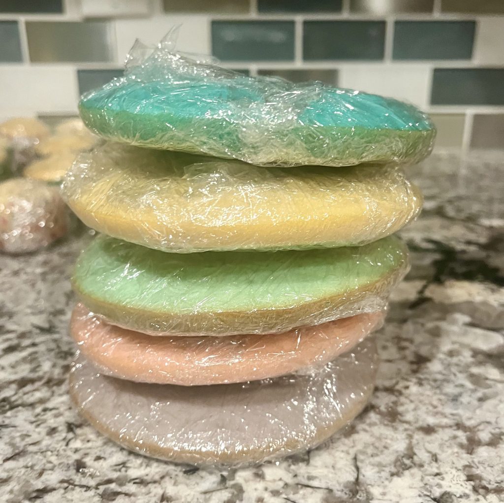 Pastel cake layers wrapped individually before frosting