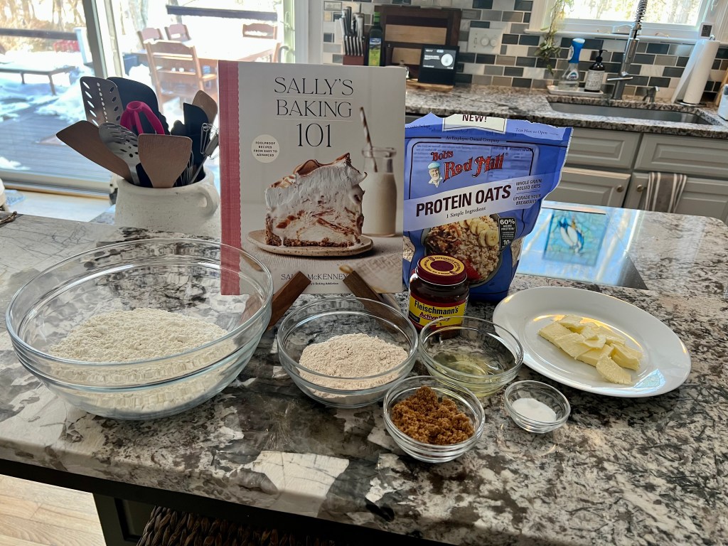 Ingredients and Sally’s Baking 101 cookbook used to make oatmeal wheat sandwich bread