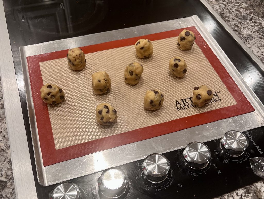 Portioned chocolate chip cookie dough balls shaped and ready for baking