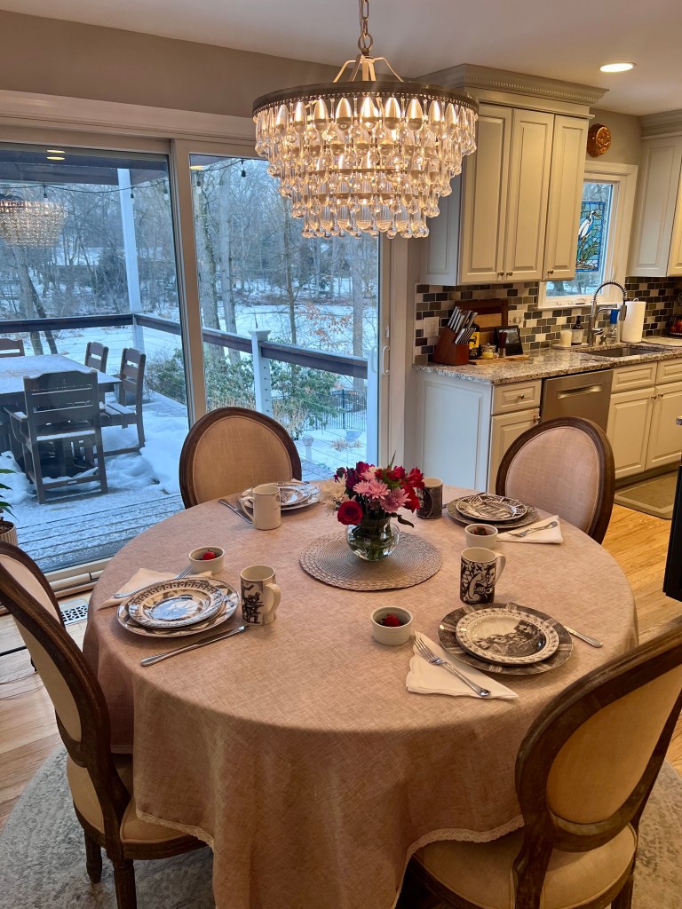 President’s Day breakfast table set with 222 Fifth Slice of Life plates, heirloom vase, white napkins, and repurposed Valentine’s flowers
