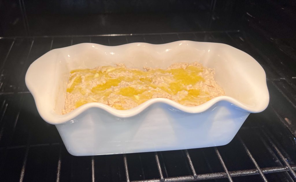 Easy Beer Bread from Sally's Baking 101 in the oven with melted butter and salt on top, ready to bake.