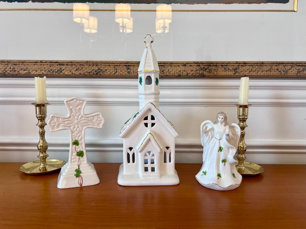 Porcelain Irish figurines with shamrocks including an angel, cross, and church used as St. Patrick’s Day decor