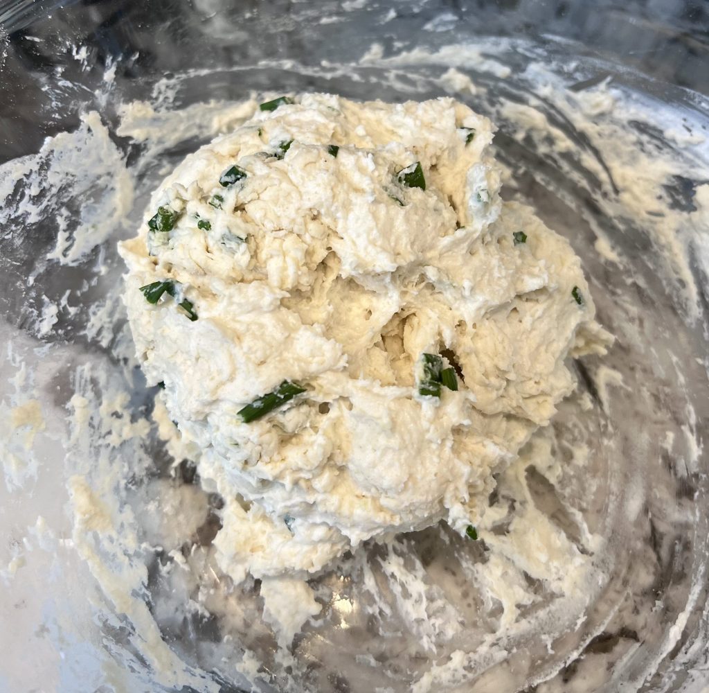 Yogurt dumpling dough mixed in a bowl, thick and slightly sticky, ready to be spooned into simmering chicken soup.