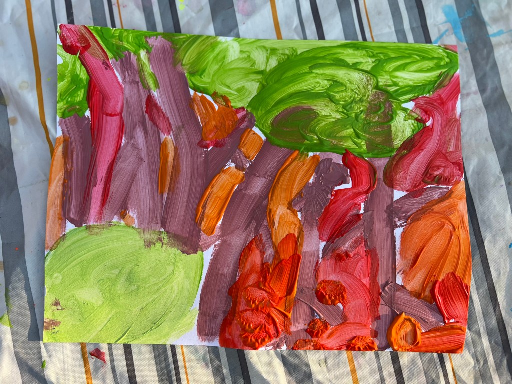 Child’s backyard painting artwork created during outdoor painting activity